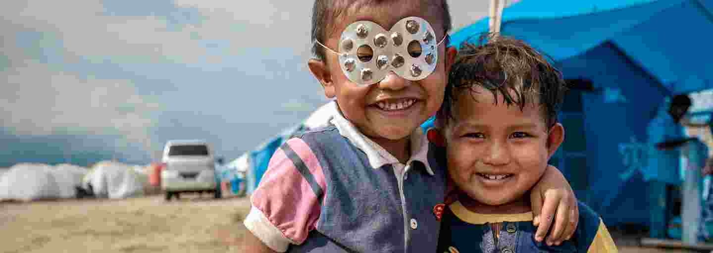 Barn leker superhjältar i ett flyktingläger.